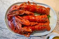 Three buttered Lobster prawns, neatly arranged on a white plate Royalty Free Stock Photo