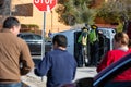 Three bystanders Watch Emergency Responders Clearing a Crashed Minivan