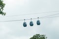 Three cable cars against cloudy sky in summer