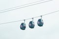 Three cable cars against cloudy sky in summer