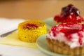 three cakes with strawberries, slices of kiwi cherry and strawberry jam Royalty Free Stock Photo