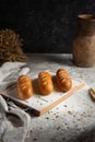 Three cakes on wooden board and gray background