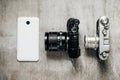 Three camera retro and modern mobile phone on a light gray background