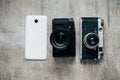 Three camera retro and modern mobile phone on a light gray background