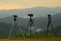 Three camera tripods photographer sunset. Royalty Free Stock Photo