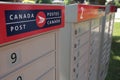 three canada post community mailboxes with logo top frame left Royalty Free Stock Photo