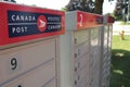 three canada post community mailboxes with logo top frame left Royalty Free Stock Photo