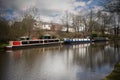 Three canal narrowboats moored on the Leeds Liverpool canal