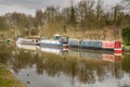 Three canal narrowboats moored on the Leeds Liverpool canal