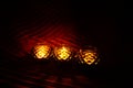 Three candle holders in the dark Royalty Free Stock Photo