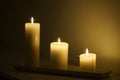 Three candles burning in the darkness. Royalty Free Stock Photo