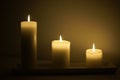 Three candles burning in the darkness. Royalty Free Stock Photo