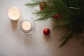 three candles and a christmas tree on a table. Generative AI Royalty Free Stock Photo