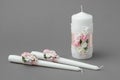 Three candles decorated with beautiful roses, pearls, pink silk ribbons and lace