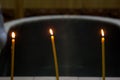 Three candles on the edge of the font in the Russian Orthodox Church Royalty Free Stock Photo