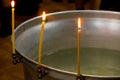 Three candles on the edge of the font in the Russian Orthodox Church Royalty Free Stock Photo