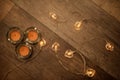 Three candles and heart shaped electric lights decorative string on laminated wooden floor