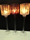 Three Candles in a row lighted up in a dark night of your room Royalty Free Stock Photo