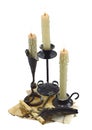 Three candles with written implements