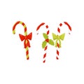 Three candy canes decorated with bright bows and red berries with green leaves. Traditional Christmas sweets. Flat