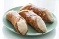 Three delicious cannoli on a green plate, typical Sicilian pastry Royalty Free Stock Photo