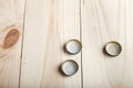 Three caps from beer on a wooden board, Royalty Free Stock Photo