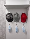 Three caps and masks hang in the hallway Royalty Free Stock Photo