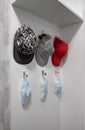 Three caps and masks hang on a hanger Royalty Free Stock Photo