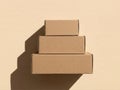 Stack of cardboard boxes with long shadow on beige background minimalist eco packaging concept Royalty Free Stock Photo