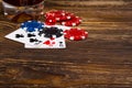 Three cards, poker chips, on a wooden background