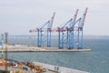 Three cargo cranes in the port. Cargoes in the port