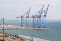 Three cargo cranes in the port. Cargoes in the port Royalty Free Stock Photo