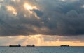 Three cargo freight ships on horizon