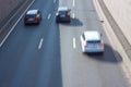 Three cars are driving on a three-lane road. Aerial view of the road