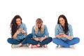 Three casual women sitting and texting