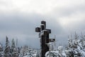 Three catholic crosses after a heavy snowstorm near a pine forest Royalty Free Stock Photo