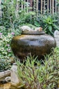 Three cats ceramic on earthenware fountain jar Royalty Free Stock Photo