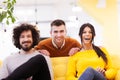 Three caucasian positive and happy colleagues in a modern office