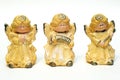 Three ceramic figurines of angels yellow on a white background