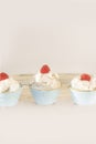 Three ceramic jars with cream and raspberry