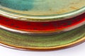 Three ceramic plates of different colors. Part of the frame