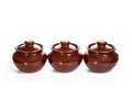 Three ceramic pots for oven isolated on white background Royalty Free Stock Photo