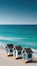 Three charming beach huts stand side by side on a pristine sandy shore, embraced by a clear blue sky and gentle waves Royalty Free Stock Photo