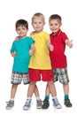 Three cheerful boys hold his thumbs up