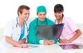 Three cheerful doctors looking at an x ray