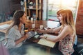 Three cheerful female high-school students preparing for exam in a school library. Royalty Free Stock Photo