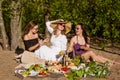 Three cheerful girlfriends at a summer picnic. Happy women