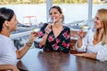 Girlfriends sit at a table with a wine glass drinking. Royalty Free Stock Photo