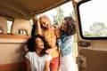 Three cheerful women having fun during road trip Royalty Free Stock Photo