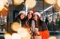 Three cheerful women spends Christmas holidays together outdoors. Conception of new year Royalty Free Stock Photo